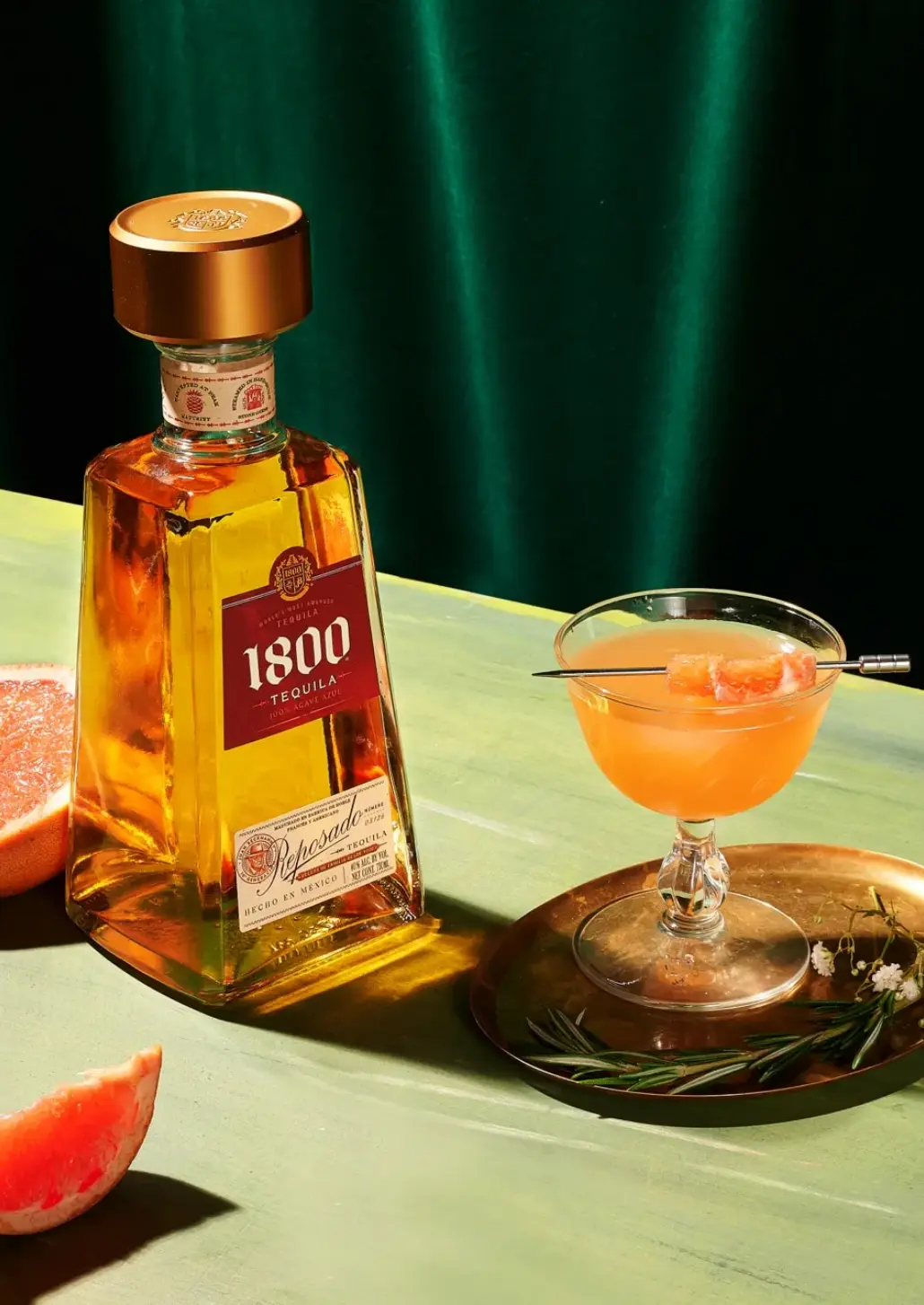 bottle of 1800 reposado and coupe glass of the rosada cocktail