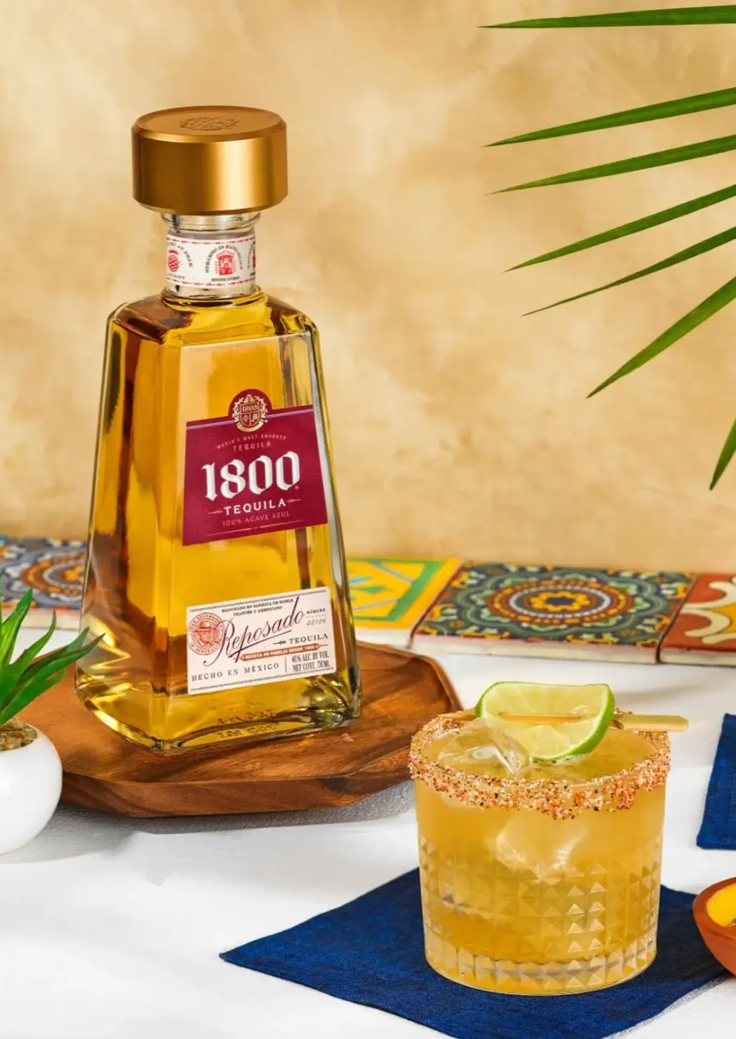 bottle of 1800 reposado with a rocks glass of tequilada